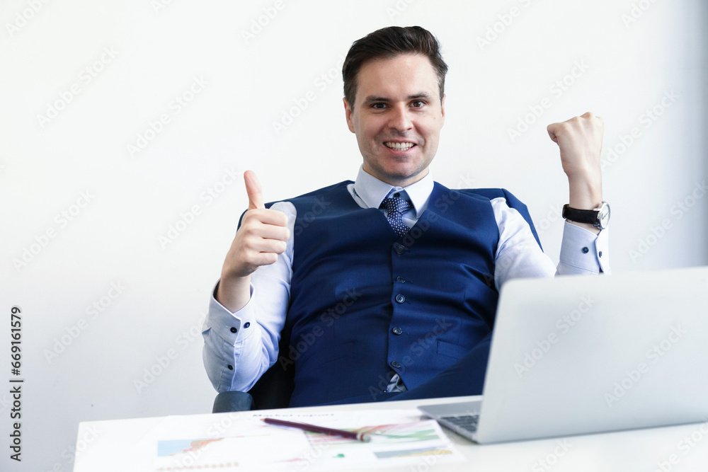 excited financial businessman sitting on chair celebrating success. CEO wearing suit celebrating success at business in office. excited financial businessman sitting on chair celebrating success. CEO wearing suit celebrating success at business in office.