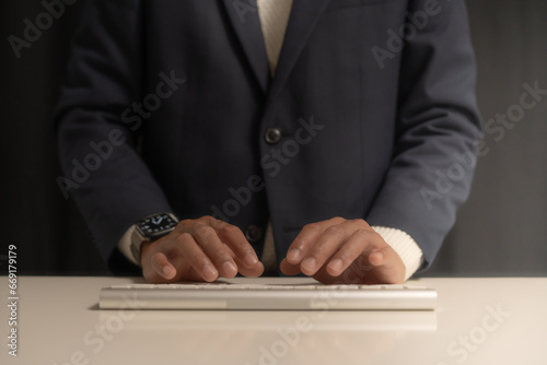 close up of a person typing on a laptop in the business man style 
