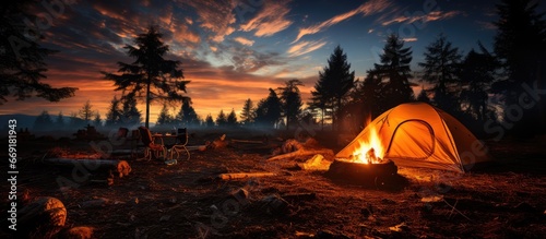night camping near a bright fire in a pine forest under a starry night sky. campfire, Tourism, camping concept