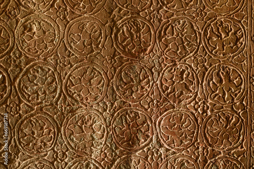 Detail of a relief drawing in the form of a repeating pattern of mythological figures and plant motifs at the Angkor Wat temple in Cambodia, near Siem Riep.