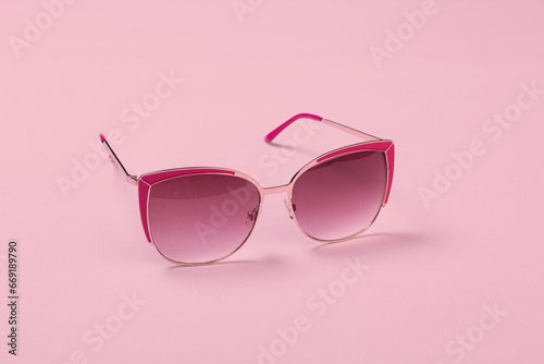 Sunglasses on colorful background with stylish modern frame in studio shot with copy space