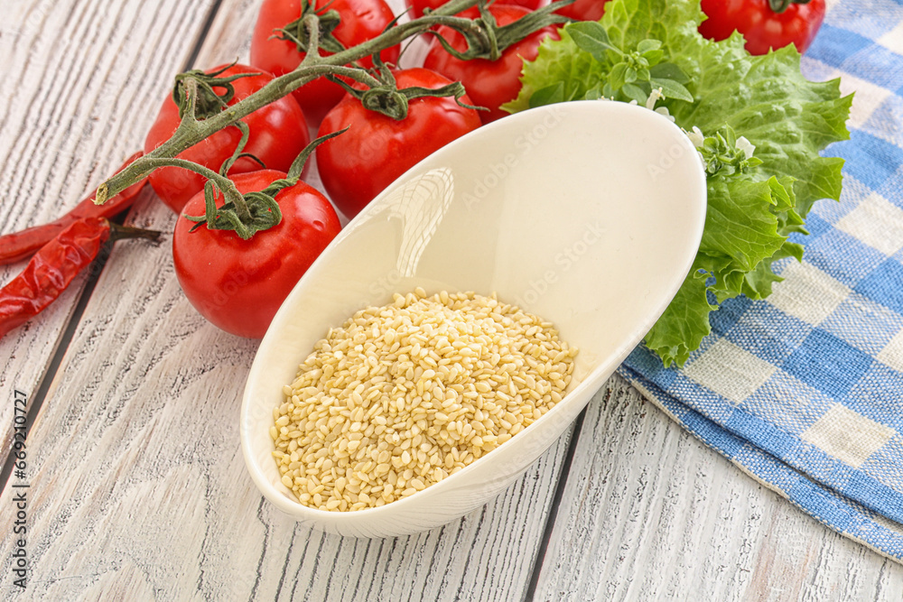 Raw sesame seeds in the bowl Raw sesame seeds in the bowl