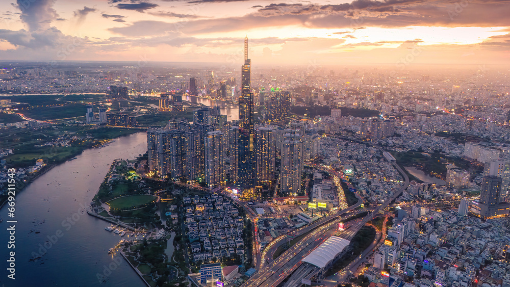 Aerial sunset view at Landmark 81 - it is a super tall skyscraper and Saigon bridge with development buildings along Saigon river, cityscape in the night - obrazy, fototapety, plakaty 