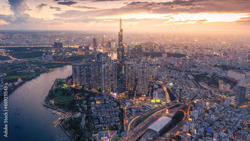 Aerial sunset view at Landmark 81 - it is a super tall skyscraper and Saigon bridge with development buildings along Saigon river, cityscape in the night photo