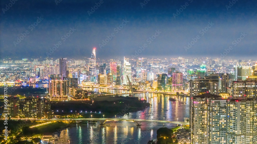 Aerial view of Ho Chi Minh City skyline and skyscrapers on Saigon river, center of heart business at downtown, cityscape in the night