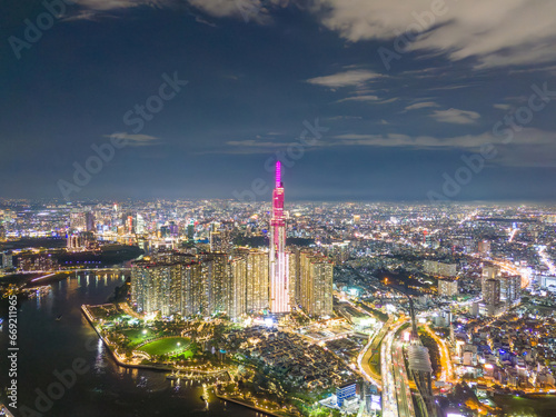 Aerial sunset view at Landmark 81 - it is a super tall skyscraper and Saigon bridge with development buildings along Saigon river, cityscape in the night