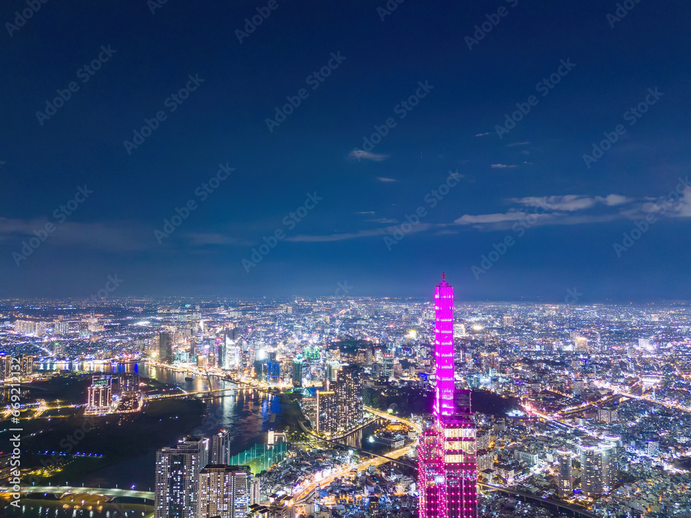 Aerial sunset view at Landmark 81 - it is a super tall skyscraper and Saigon bridge with development buildings along Saigon river, cityscape in the night
