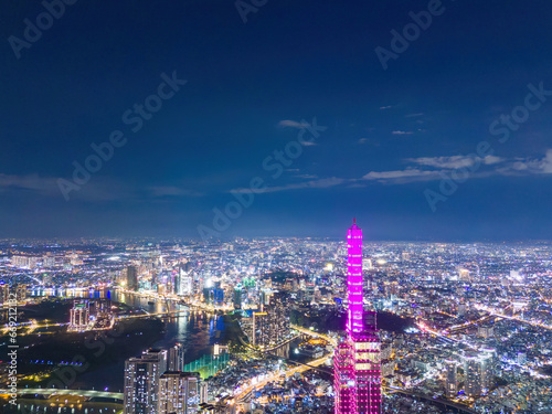 Aerial sunset view at Landmark 81 - it is a super tall skyscraper and Saigon bridge with development buildings along Saigon river  cityscape in the night