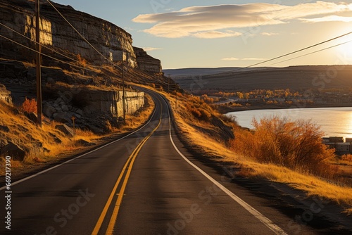 Serene Sunset Drive. Captivating Road Fading into Majestic Horizon Between Mountains and Seascape. photo