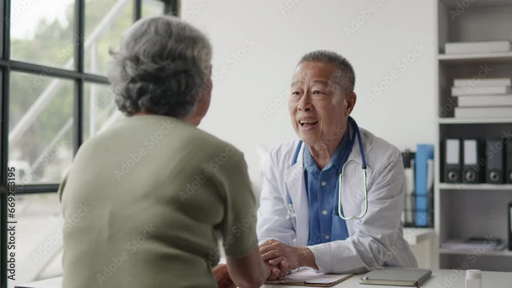 Doctor is advised treatment methods and recovery then touching patient hands for encouragement and support to old woman patient. Doctor is advised treatment methods and recovery then touching patient hands for encouragement and support to old woman patient.