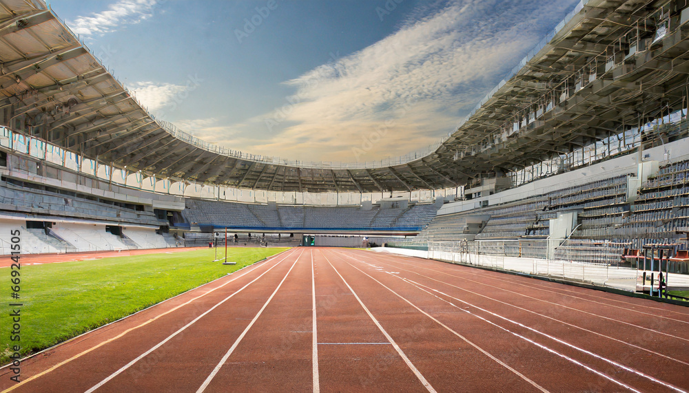 front view of an athletics stadium with a racetrack and starting blocks generative ai