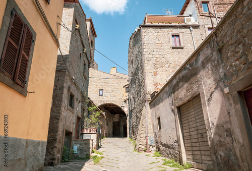 narrow street with traditional old houses in the medieval old town of Viterbo, Lazio, Italy