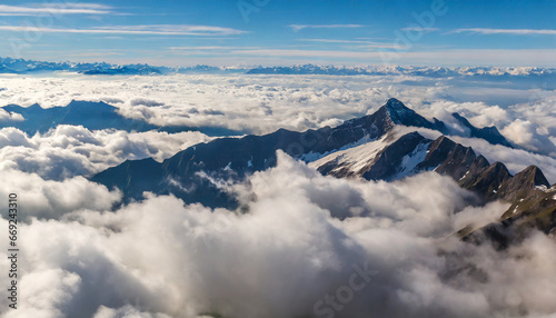 a view of a mountain range from above the clouds in the sky generative ai © Alicia