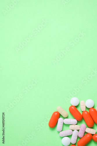 colorful medical pills on green background with copy space, supplement, vitamin, colorful © ahmadfaiz