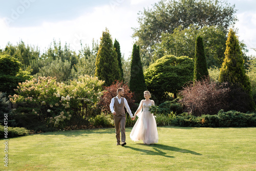 wedding walk of the bride and groom in a coniferous in elven accessories