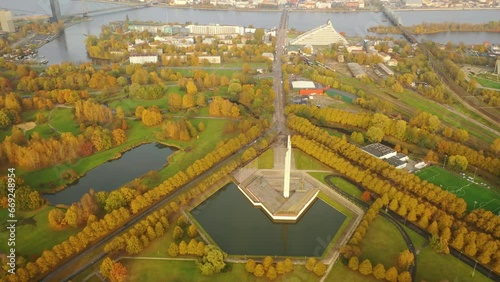 Aerial 4K video from drone to of Victory Monument In Riga (Uzvaras Piemineklis), golden autumn. World War II Victory Monument to Soviet Army in Riga. Riga, Latvia, Europe  v photo