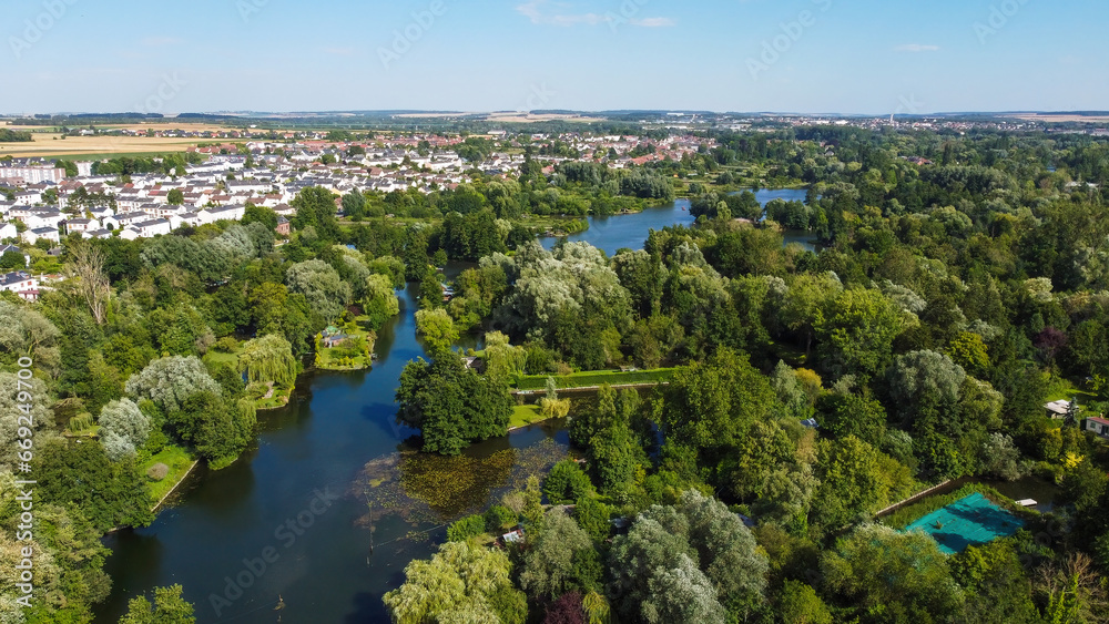 Fototapeta premium Aerial view of the Hortillonnages of Amiens made of several islands covered with gardens sheds and plantations in a swampy area of the river Somme in Picardie, France