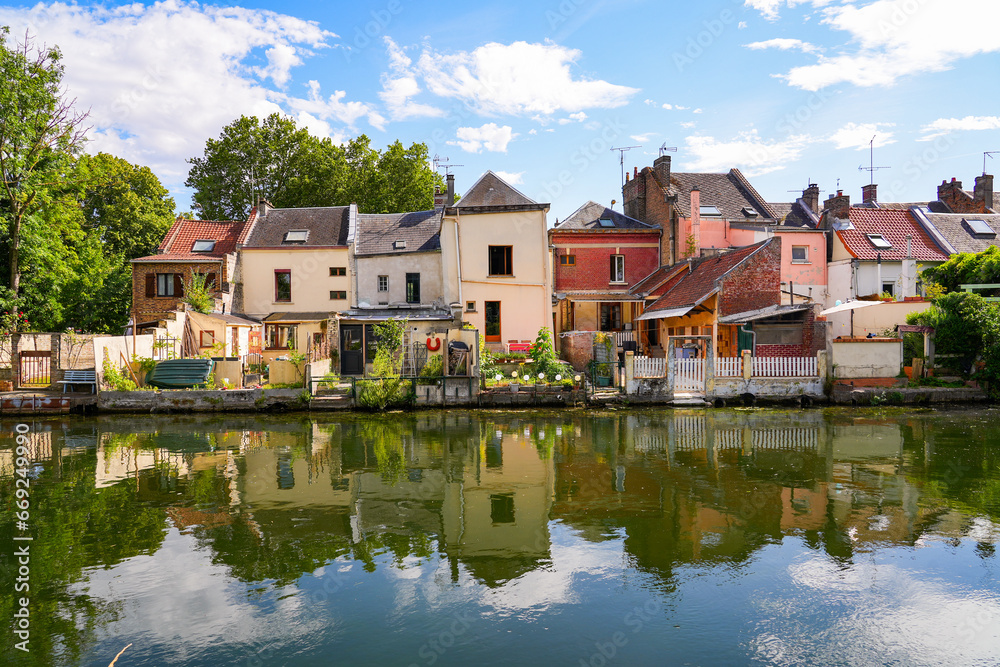 Houses built on the banks of the river Somme opposite the famous Hortillonnages of Amiens in Picardy, France