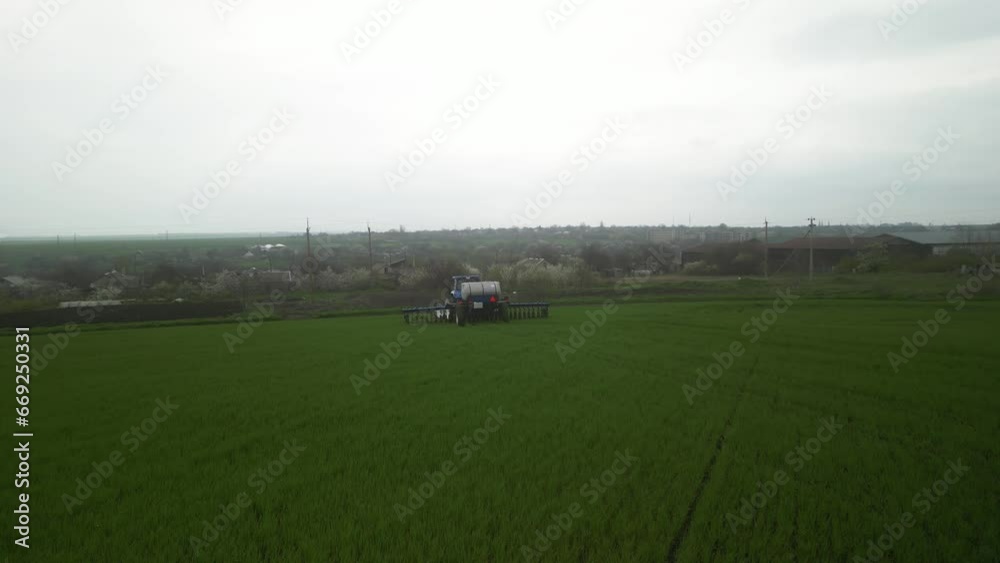 Tactor on the field doing liquid fertilizer injection Tactor on the field doing liquid fertilizer injection