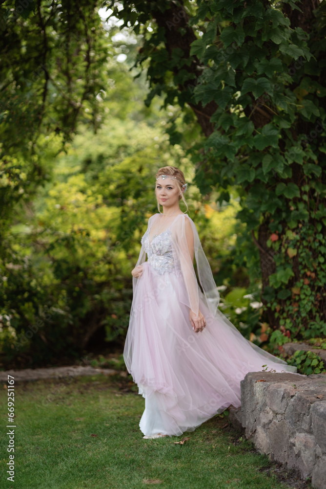 portrait of a happy bride in a light light dress in  wearing elven accessories