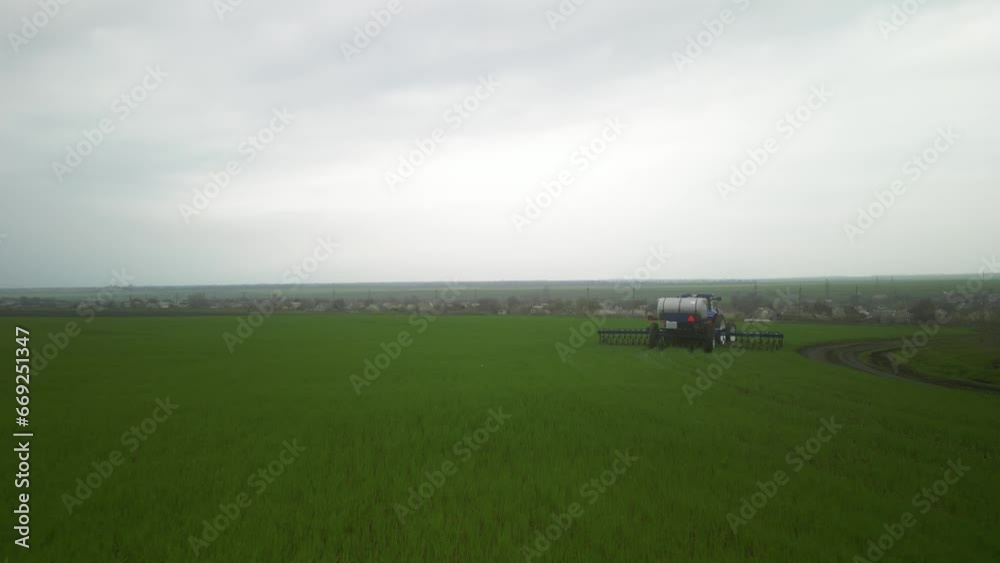 Tactor on the field doing liquid fertilizer injection Tactor on the field doing liquid fertilizer injection