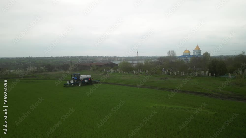 Tactor on the field doing liquid fertilizer injection Tactor on the field doing liquid fertilizer injection
