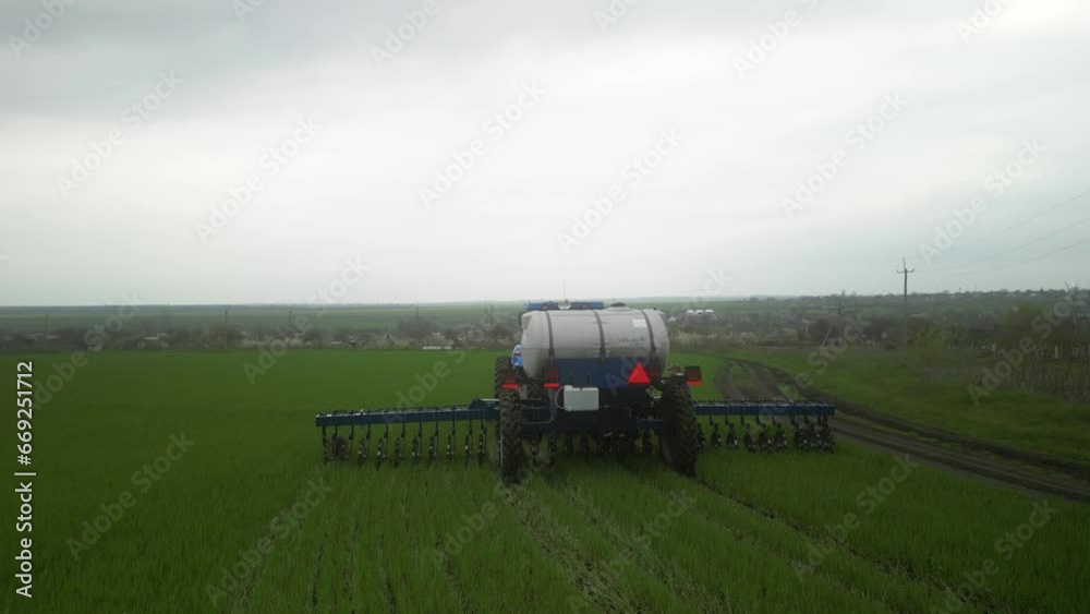 Tactor on the field doing liquid fertilizer injection Tactor on the field doing liquid fertilizer injection