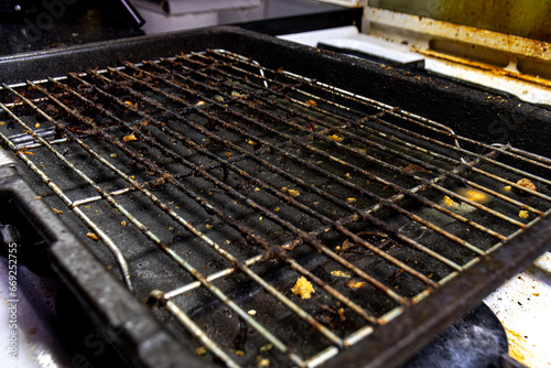 A very dirty and greays grill tray