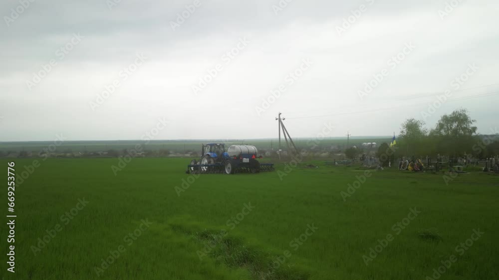 Tactor on the field doing liquid fertilizer injection Tactor on the field doing liquid fertilizer injection