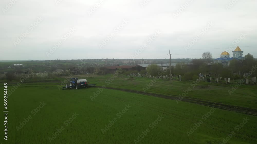Tactor on the field doing liquid fertilizer injection Tactor on the field doing liquid fertilizer injection