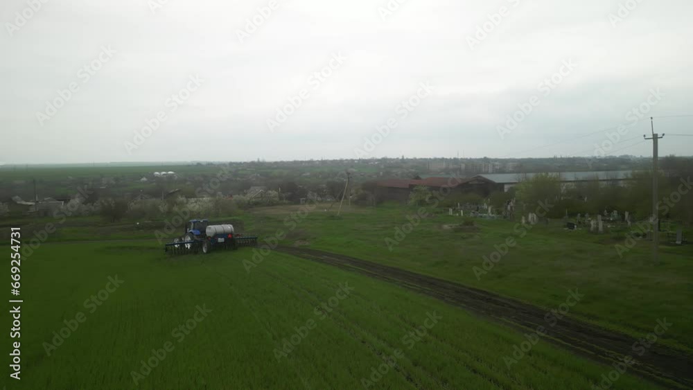 Tactor on the field doing liquid fertilizer injection Tactor on the field doing liquid fertilizer injection