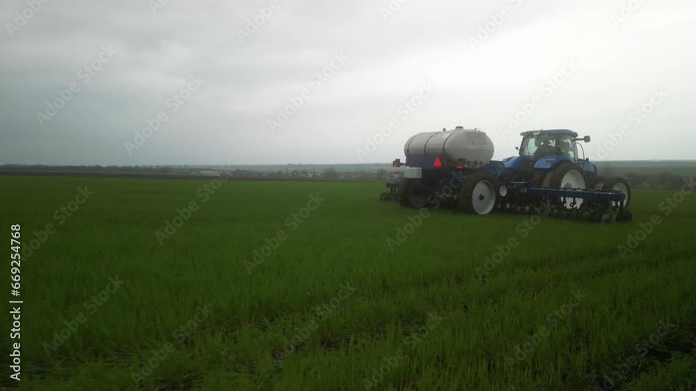 Tactor on the field doing liquid fertilizer injection Tactor on the field doing liquid fertilizer injection