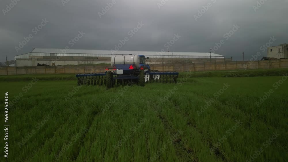 Tactor on the field doing liquid fertilizer injection Tactor on the field doing liquid fertilizer injection