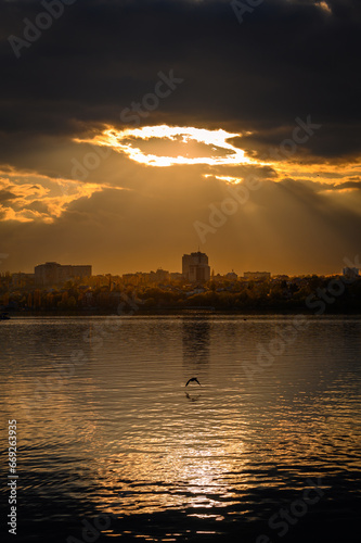 Sunset on the river with a glowing circle in the sky