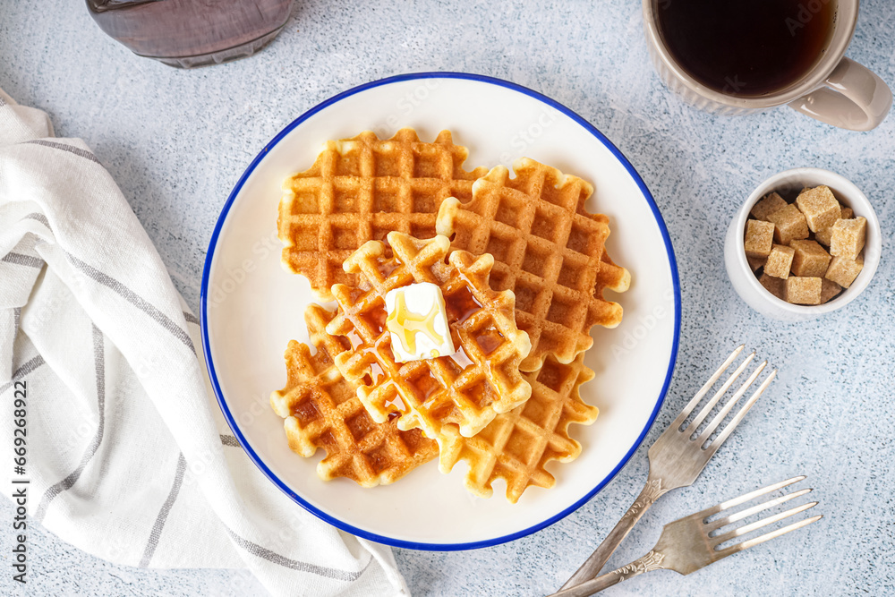 Plate of tasty waffles with maple syrup on white background Plate of tasty waffles with maple syrup on white background
