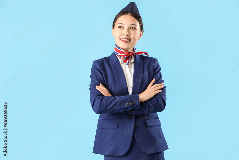 Beautiful Asian stewardess on blue background Beautiful Asian stewardess on blue background