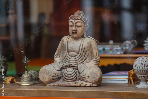 Little Buddha statue in window