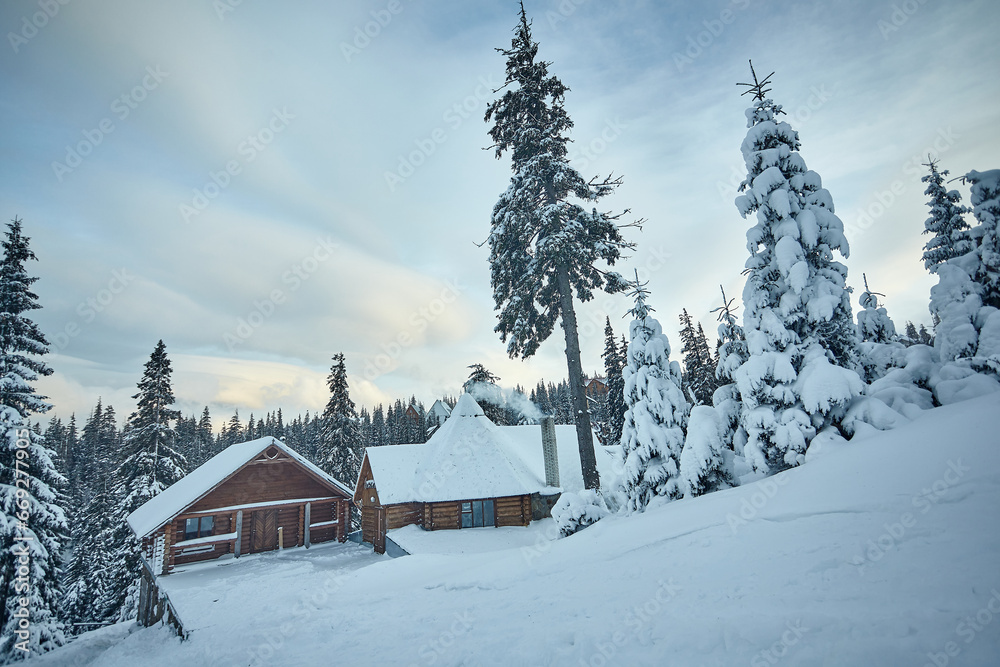 Beautiful chalet in a snowy forest, winter holiday