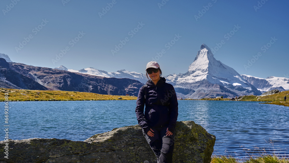 Woman hiking in the Swiss Alps with Matterhorn in background