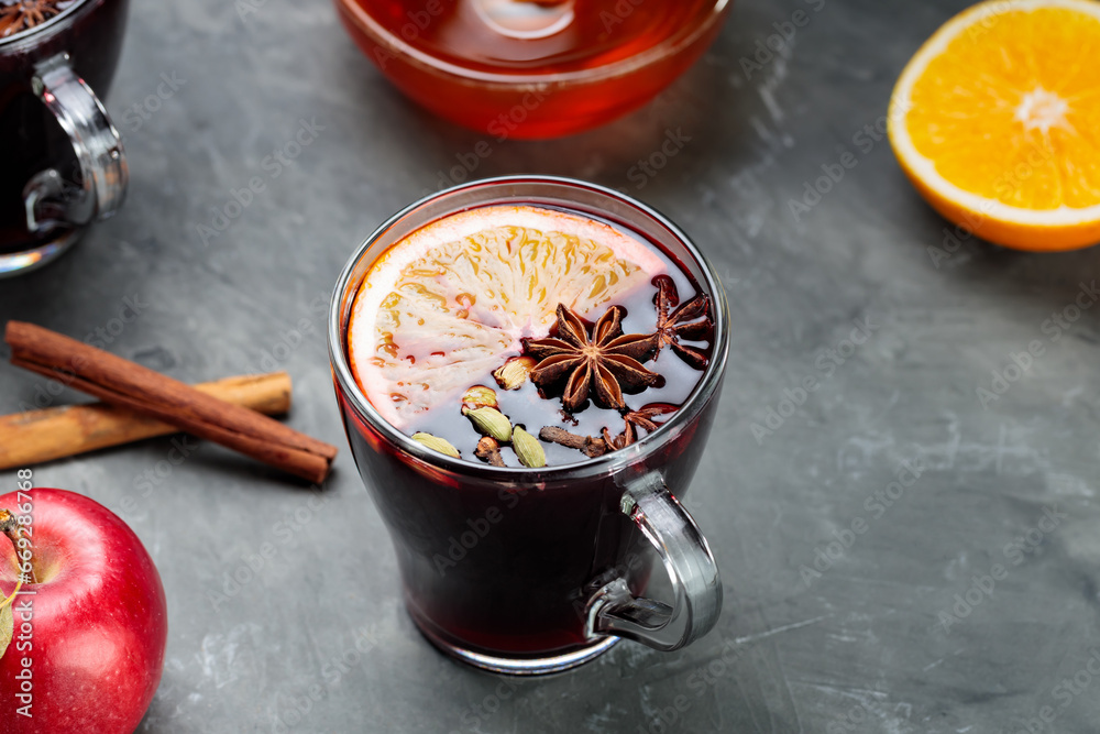 Mulled wine in transparent mugs with spices and citrus fruit dark background. Autumn and winter drink Mulled wine in transparent mugs with spices and citrus fruit dark background. Autumn and winter drink
