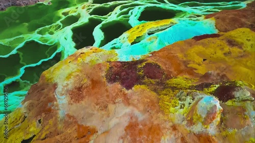 Dallol volcano, Danakil Depression, Ethiopia. Amazing top down aerial view. Colorful sulfur ponds at sunrise. Cinematic drone reveal of incredible natural landscape. Famous travel destination landmark