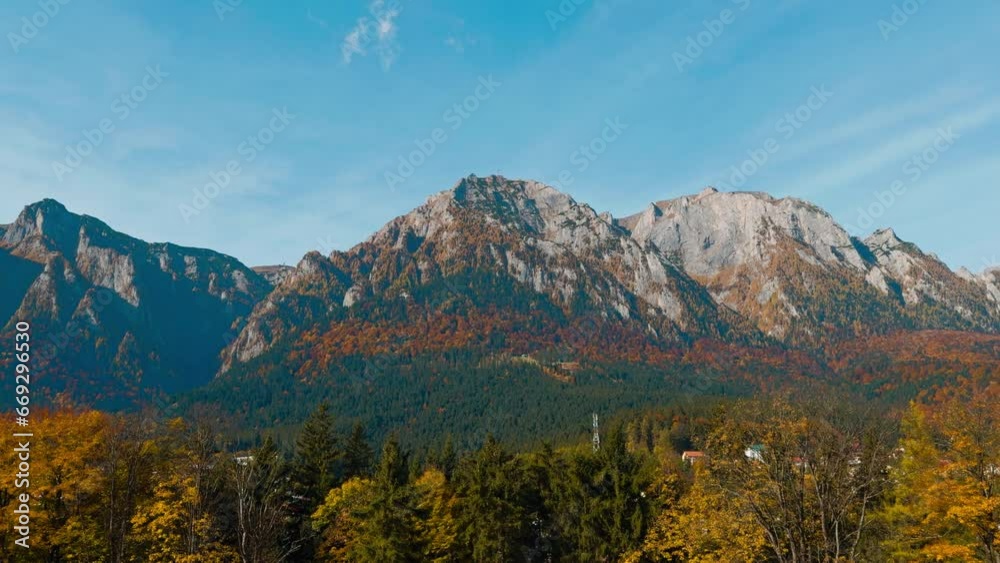 Gorgeous bare mountains with green forest at the foot. Rocks lit with sunlight on beautiful sunny autumn day. Gorgeous bare mountains with green forest at the foot. Rocks lit with sunlight on beautiful sunny autumn day.
