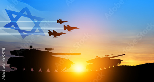 Silhouettes of army tanks and fight planes on background of sunset with a transparent waving Israel flag.