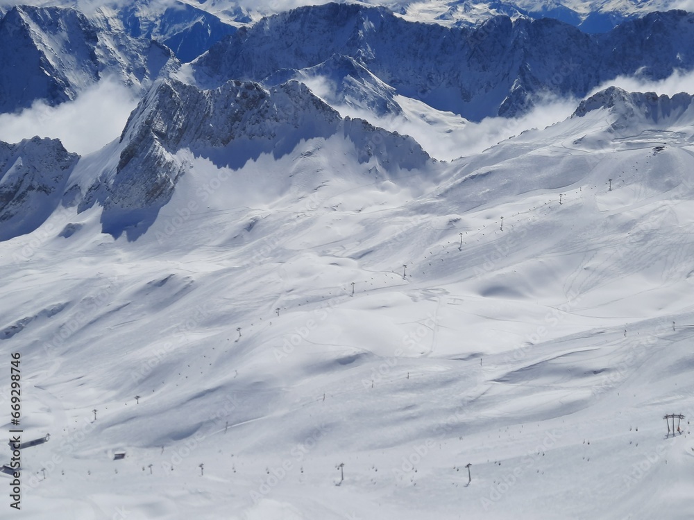 Ski resort on a clear Sunny day. Snow on the Zugspitze mountain height -2962 m. in Bavaria, Germany Ski resort on a clear Sunny day. Snow on the Zugspitze mountain height -2962 m. in Bavaria, Germany