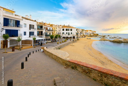 Sandy beach in front of the whitewashed fishing village of Calella de Palafrugell along the Costa Brava coastline of the Girona Province, Southern Spain. photo