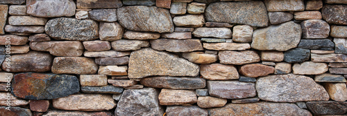 textured stone wall, a symbol of strength and resilience, with natural light casting captivating shadows