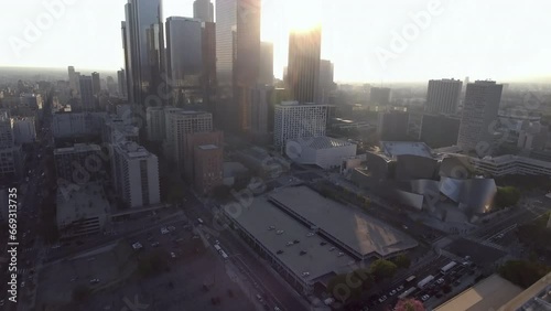 Aerial Tilt Up Shot Of Vehicles On Streets Amidst Modern Buildings In City At Sunset - Los Angeles, California