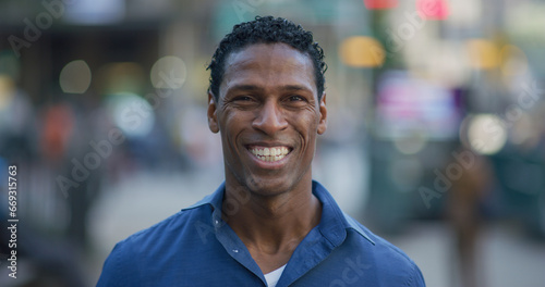 Black man smiling happy face portrait on city street