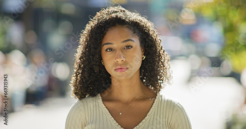 Young black woman serious face portrait on city street