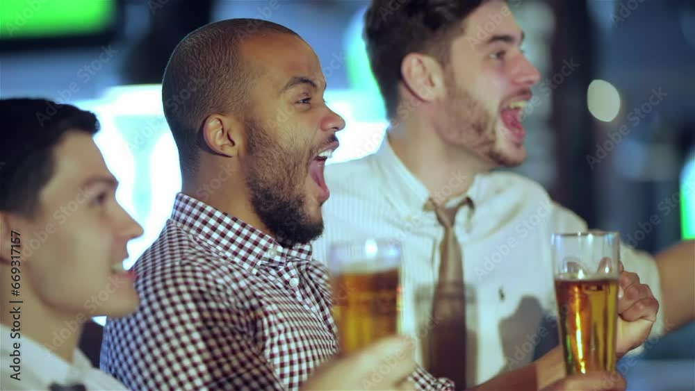 Men fans waving their hands and watching football on TV and drink beer Men fans waving their hands and watching football on TV and drink beer